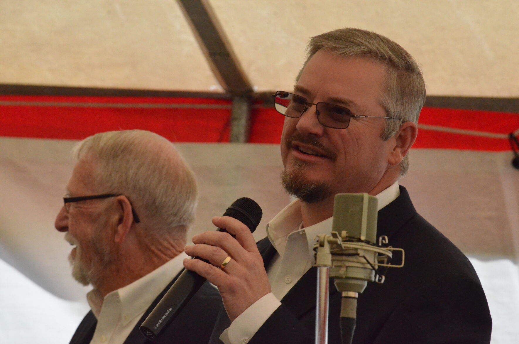 Keith Mason of the group On Bended Knee talks before his group performs at Harmony Hill Music Festival in Harmony on Saturday.
